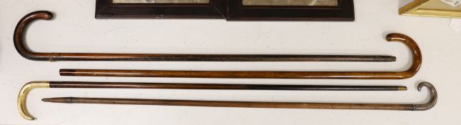 Four various walking sticks, one silver mounted and another gilt metal mounted and impressed ‘