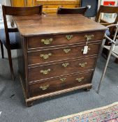 A small George II mahogany chest of drawers of four long drawers, with original brass batwing shaped