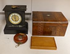 A Victorian black slate mantel clock, a parquetry writing box, a surveyor's measure, a cased