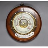 A Victorian aneroid barometer with mother-of-pearl inlaid decoration, 27cm diameter