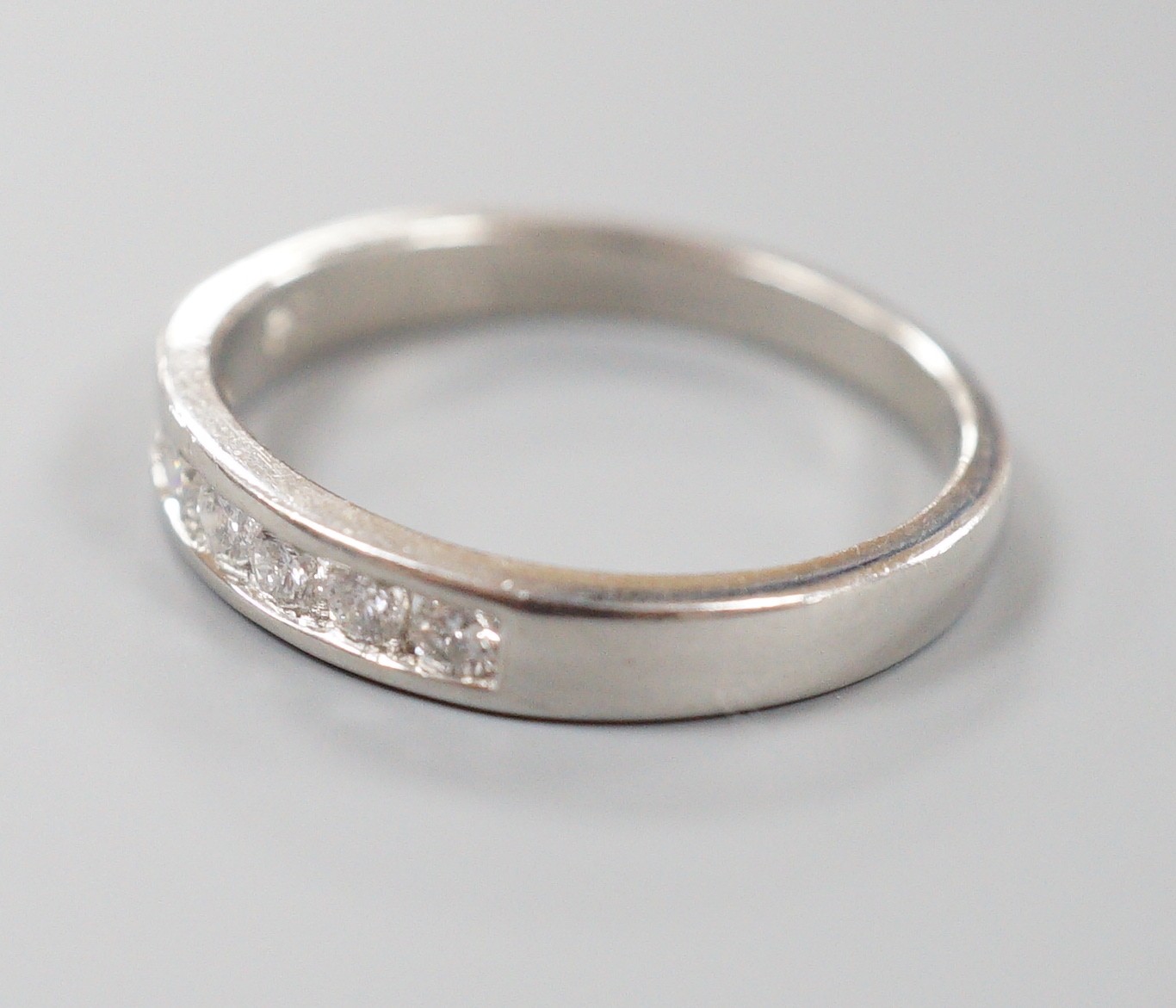 A modern platinum and channel set seven stone half hoop ring, size P, gross weight 5.1 grams, - Image 2 of 3