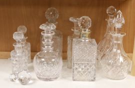 A silver mounted decanter, four others and a smaller pair of decanters, tallest 27.5cm
