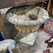 A reconstituted stone garden urn, width 54cm height 48cm