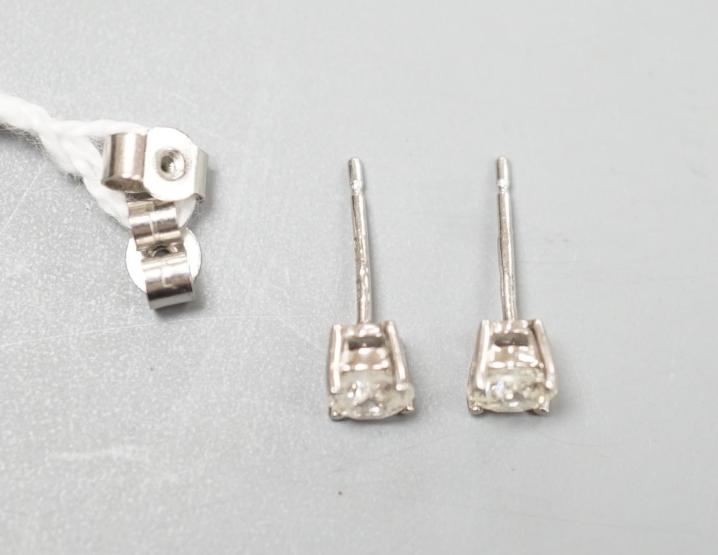 A modern pair of platinum and solitaire diamond set ear studs, total carat weight approx. 0.86ct. - Image 2 of 2