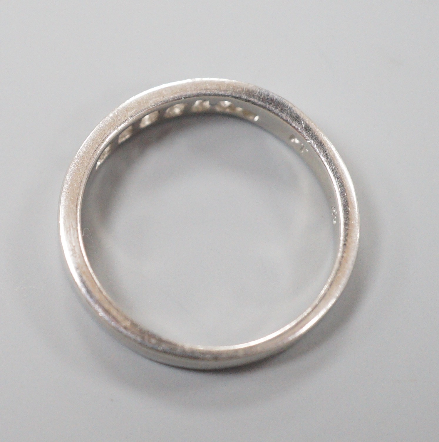 A modern platinum and channel set seven stone half hoop ring, size P, gross weight 5.1 grams, - Image 3 of 3