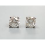 A modern pair of platinum and solitaire diamond set ear studs, total carat weight approx. 0.86ct.