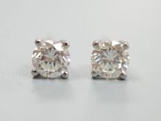 A modern pair of platinum and solitaire diamond set ear studs, total carat weight approx. 0.86ct.