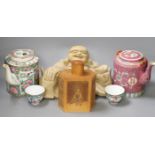 A Chinese wooden figure of Budai, two teapots in baskets and a tea caddy