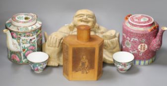 A Chinese wooden figure of Budai, two teapots in baskets and a tea caddy