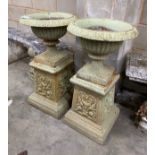 A pair of Victorian cast iron garden urns and pedestals, diameter 43cm height 80cm