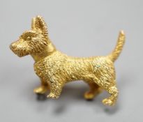 A textured yellow metal Scottie dog brooch, 24mm, 8 grams.