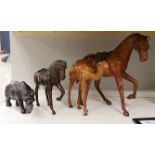 Two leather worked models of horses, a rhinoceros and a camel, tallest 42cm