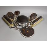 A matched George V seven piece silver and tortoiseshell pique mounted mirror, brush, toilet jar
