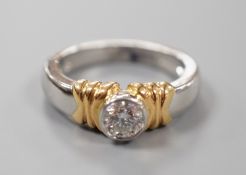 A modern platinum and yellow metal, collet set solitaire diamond ring, size L, gross weight 9.3
