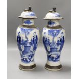 A pair of early 20th century Chinese blue and white crackle glaze vases and covers, 30cm