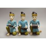 Three Malaysian painted wooden musican figures, 24cm tall