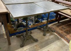 A pair of zinc top cafe tables with cast iron underframes, 60 x 60cm