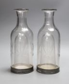 A pair of French glass carafes with silver plated bases and integral ice compartment 28cm