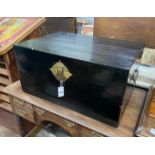A Chinese black lacquered wooden trunk, with brass loop handles, width 77cm
