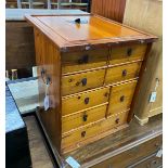 A Chinese pine cabinet housing an arrangement of eight drawers, width 48cm height 56cm