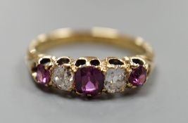 An 18ct gold, three stone ruby and two stone diamond set half hoop ring, size O, gross weight 3.7