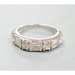 A modern 14ct gold, baguette and round cut diamond set half hoop ring, size K, gross weight 3.9