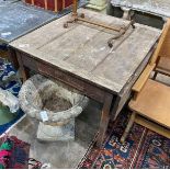 An Edwardian oak work table with drop flaps and frieze drawer, width 93cm