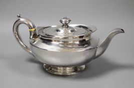 A George III squat circular silver teapot, by William Burwash, London 1820, gross 22oz. Ivory