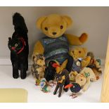 A collection of toys - a small black cat, a large black cat, a small pig, a hedgehog, a Macki