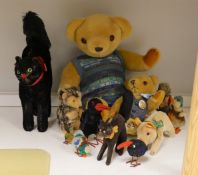 A collection of toys - a small black cat, a large black cat, a small pig, a hedgehog, a Macki