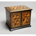 A 19th century Tunbridge ware specimen cube marquetry and coromandel table cabinet, label to