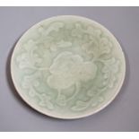 A Chinese carved celadon dish, Qing dynasty, 15cm diameter