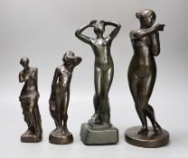 A group of four bronze finished statuettes, tallest 32cm