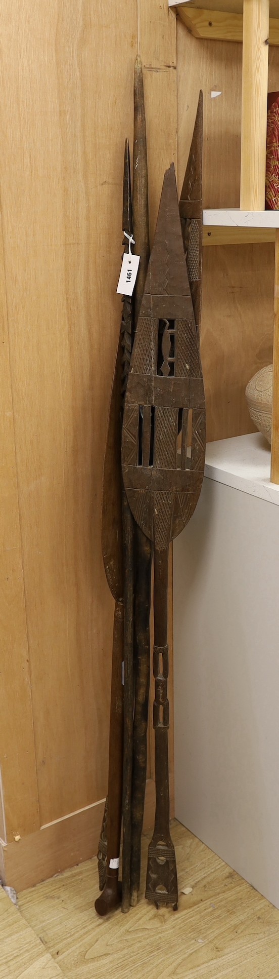 A Dayak spear paddle and four Papua New Guinea spears