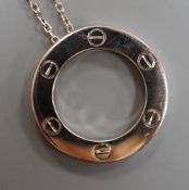A modern Italian Cartier 750 white metal 'Love' circular pendant, 24mm, numbered CRD612779, on a 750