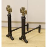 A pair of Victorian cast iron and brass fire dogs, 54cm tall