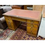 An Edwardian oak pedestal desk, width 138cm