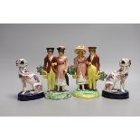 A pair of Staffordshire pink lustre spaniels and a pair of similar groups of a dandy and