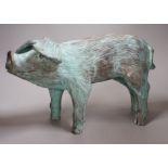 A cold cast resin bronze pig initialled 'JP', 40cm wide