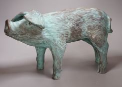 A cold cast resin bronze pig initialled 'JP', 40cm wide