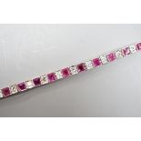 A white metal, ruby and white spinel? set line bracelet, 16cm, gross weight 8.4 grams.