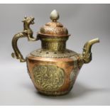 A Tibetan copper and brass ewer with dragon handles, 33cm tall