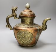 A Tibetan copper and brass ewer with dragon handles, 33cm tall