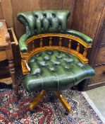 A reproduction buttoned green leather swivel desk chair, width 63cm, depth 57cm, height 84cm