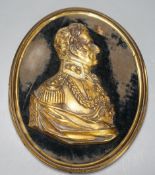 A gilt metal portrait profile relief, The Duke of Wellington, set on black velvet ground, brass