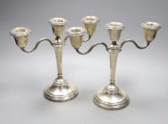 A pair of Elizabeth II silver candelabra, with loaded bases, makers Elkington & Co, Birmingham 1967,