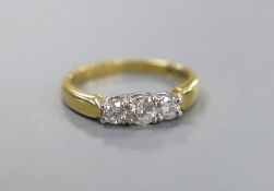 A modern 18ct gold and plat, three stone diamond set ring, size M, gross weight 4.1 grams, total