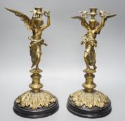 A pair of early 20th century cast brass ‘angel’ candlesticks, 36cms high