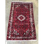 A North West Persian red ground rug, 166 x 100cm