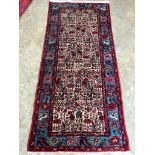 A North West Persian ivory ground rug, 192 x 88cm